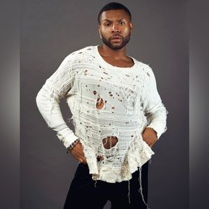 This is a handmade knit sweater by Joshua Henson in white/ off white